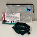 A dog training accessory set displayed on a white surface against a light gray wall, including a clear mesh zip pouch, a dark green biothane line that has a metal clip, and a printed instruction card.